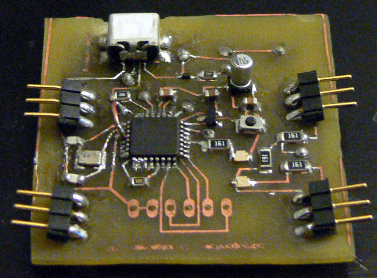 The assembled board. Note the left where there is solder up on the surface mount clock source and the arch looking jumper wire