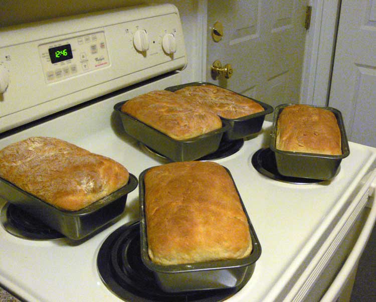 Bread cooling on the top of an electric stove.